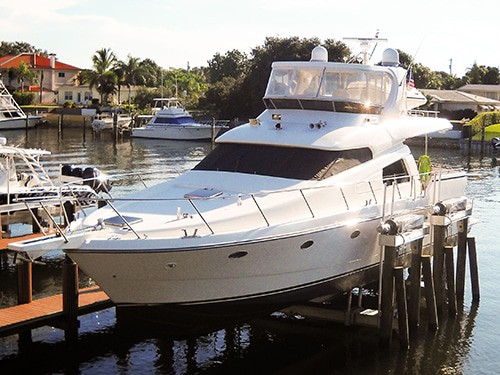 White boat rests securely on IMM Quality Titan Yacht Lifts