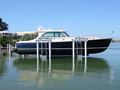 This large navy and white boat rests on an IMM Quality boat lift
