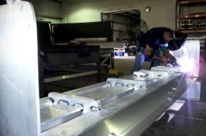 Employee welding metal