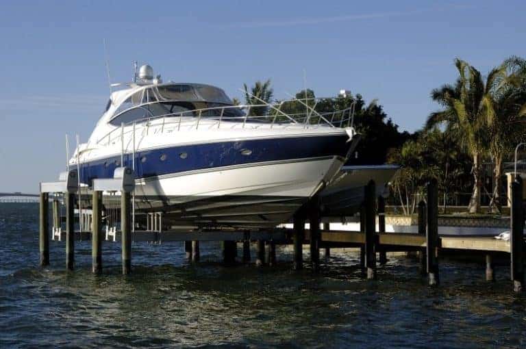 Superlift boat lift by IMM Quality holds white and blue yacht
