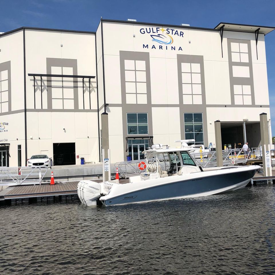 Blue and white boat is raised from the water using an IMM Quality custom superlift at Gulf Star Marina in Fort Myers