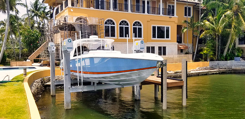 IMM-33K-beamless-3-Lum Beamless boat lift with blue yacht makes it easy to walk onto the boat from the dock
