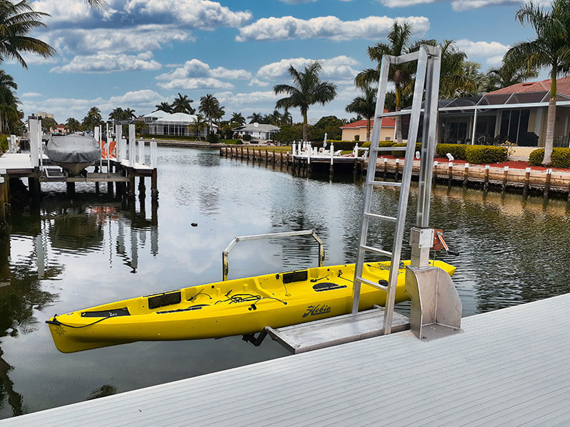 Side view of yellow kayak secured by this residential kayak dock lift