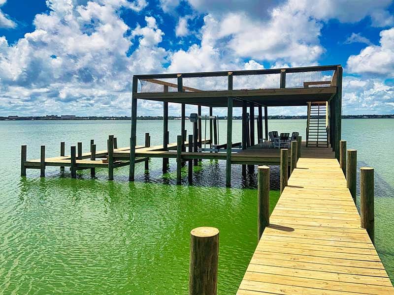 Large boathouse with IMM Quality custom boat lifts requires little to no boat lift maintenance