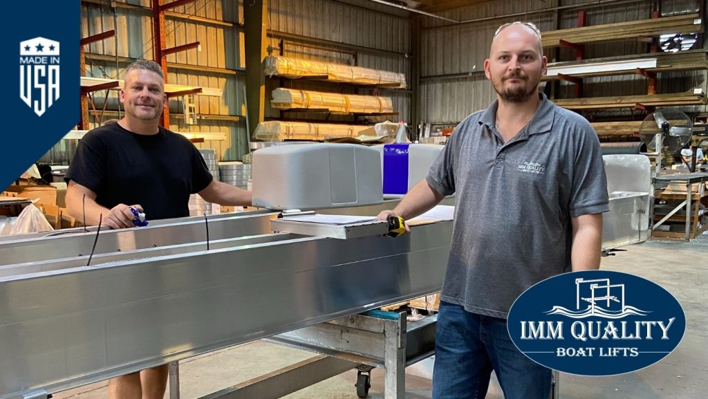 Two IMM Quality assembly staff show off one of the world's best boat lifts