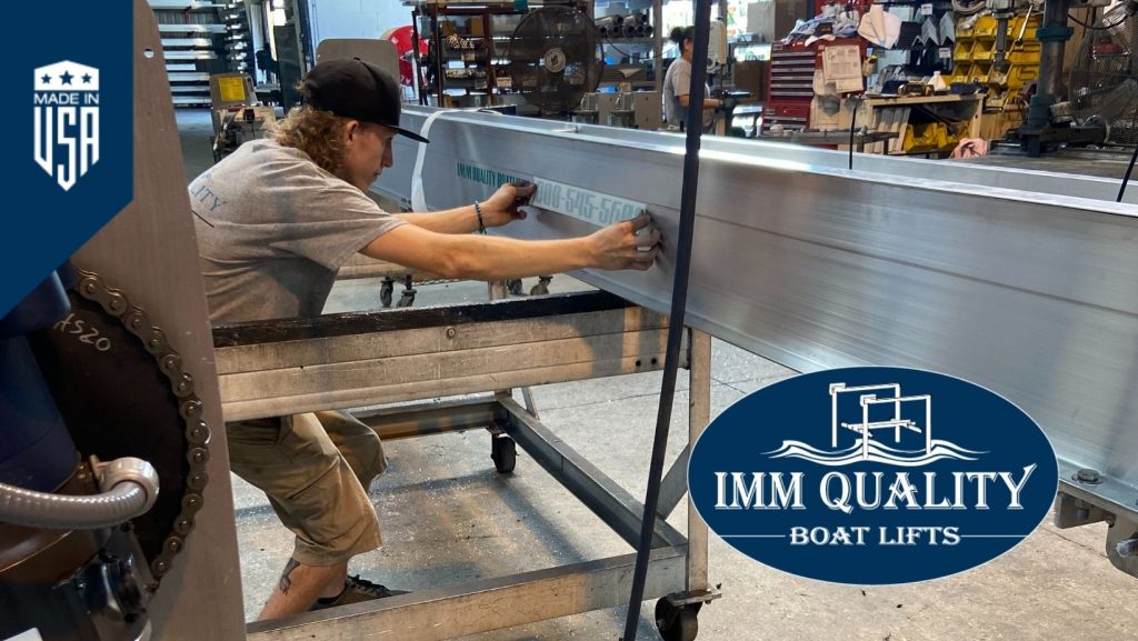 IMM Quality Boat Lifts employee places company sticker on boat lift in advance of National Employee Appreciation Day