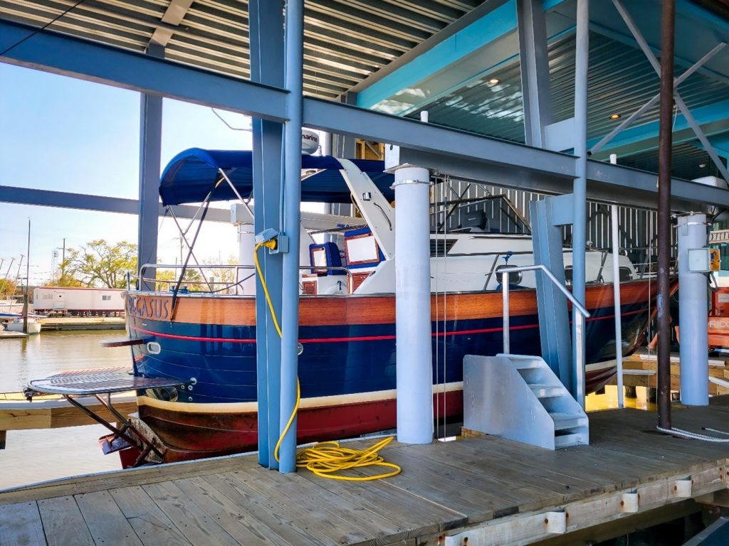 New carbon fiber piling technology installed by diversion boat lift company holds marina boat above water