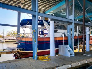 New carbon fiber piling technology installed by diversion boat lift company holds marina boat above water